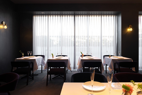 Elegant restaurant dining area with chic decor and natural light