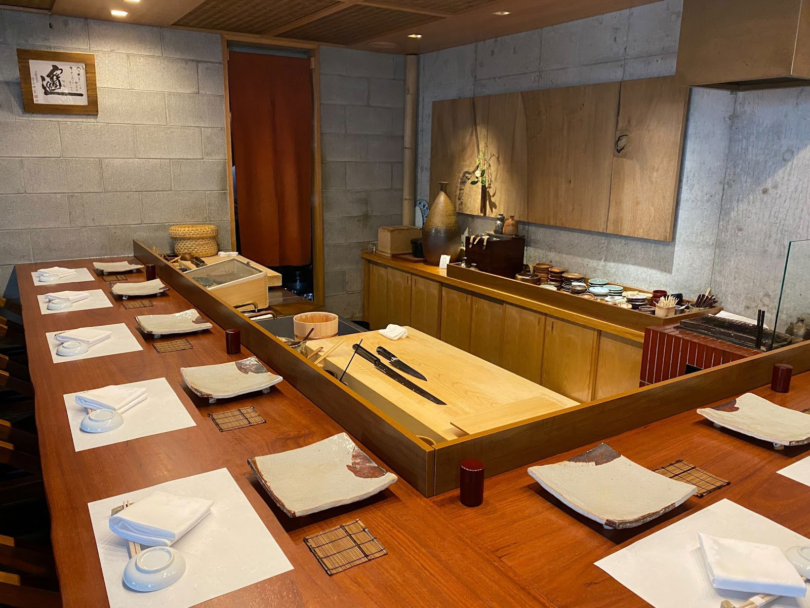 Kappo counter seating at Nishiazabu Taku, with the tables laid and the cooking utensils prepared.