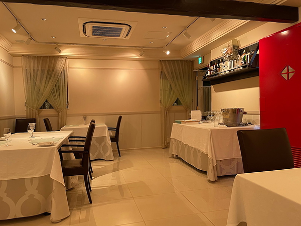 Elegant restaurant interior with white table settings and soft lighting