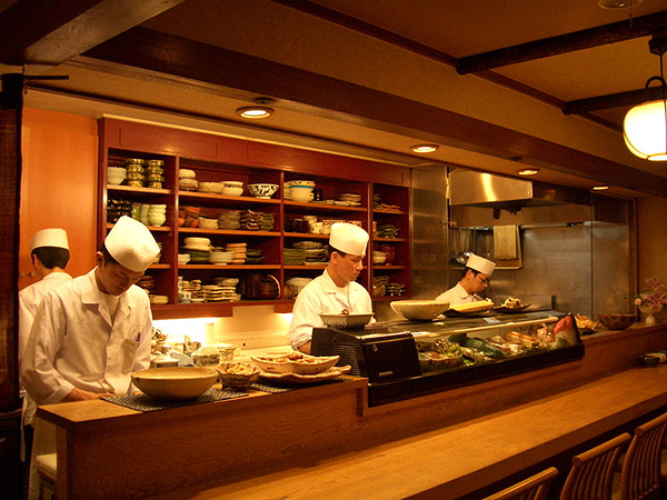 Chefs preparing gourmet dishes in a bustling restaurant kitchen