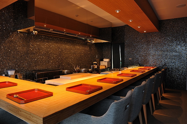 Elegant sushi bar with wooden countertop and sleek modern design