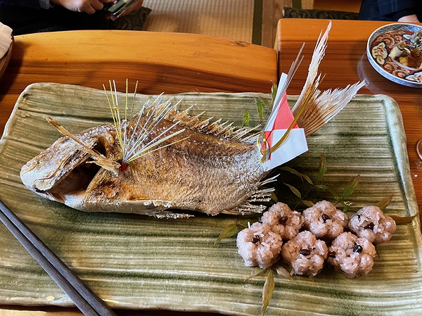 Grilled fish with decorative garnish on traditional platter