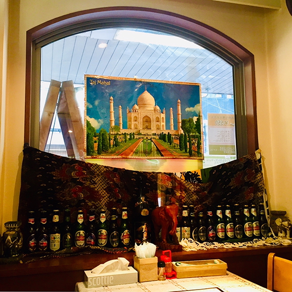 Taj Mahal poster and Indian beer display in restaurant window