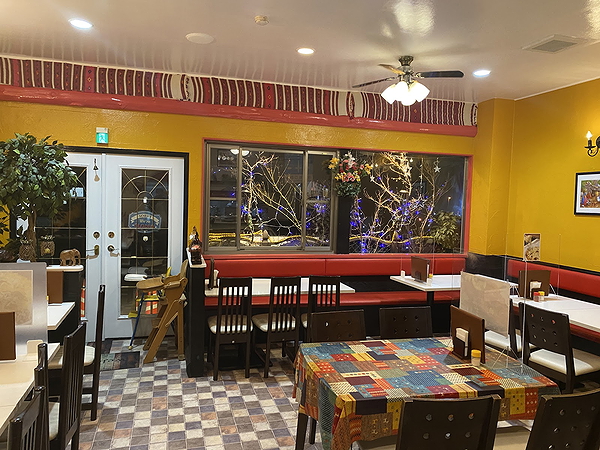 Cozy restaurant interior with colorful tablecloths and ambient lighting