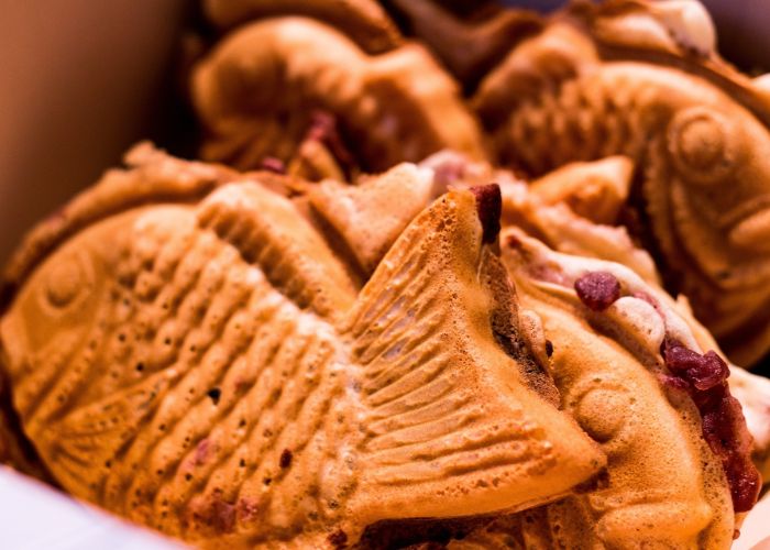 A close up shot of several golden taiyaki cakes together