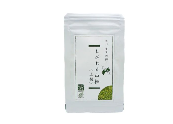 A white and green packet of sansho powder against a white background