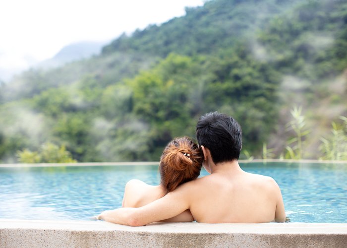 Young couple relaxing in a hot spring