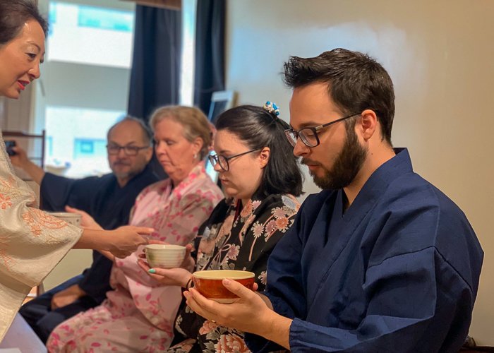 Four people in kimono enjoy a tea ceremony