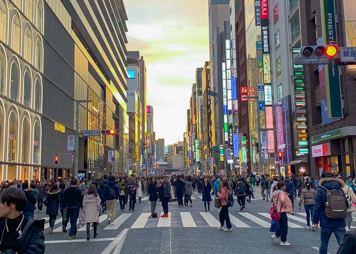 People walk on a wide street in Ginza on Sunday