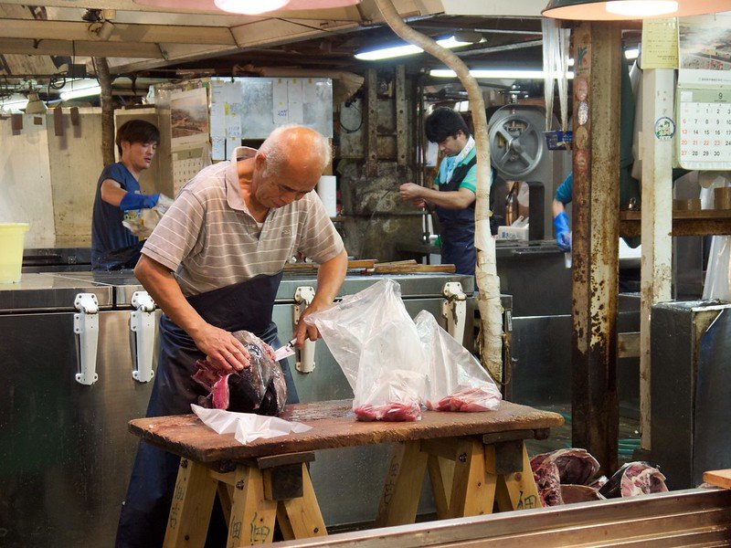 Man cutting up fish at a Tokyo fish market