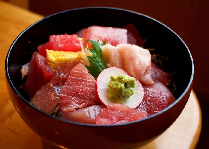 An image of a bowl of donburi topped with fresh red tuna