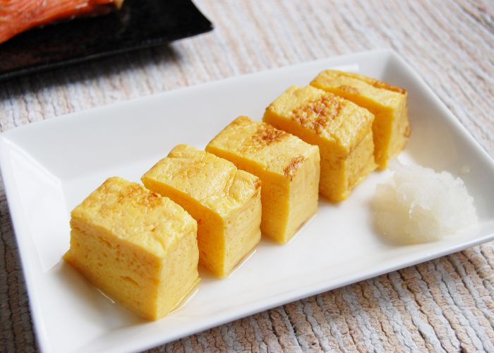 A plate of tamagoyaki with grated daikon