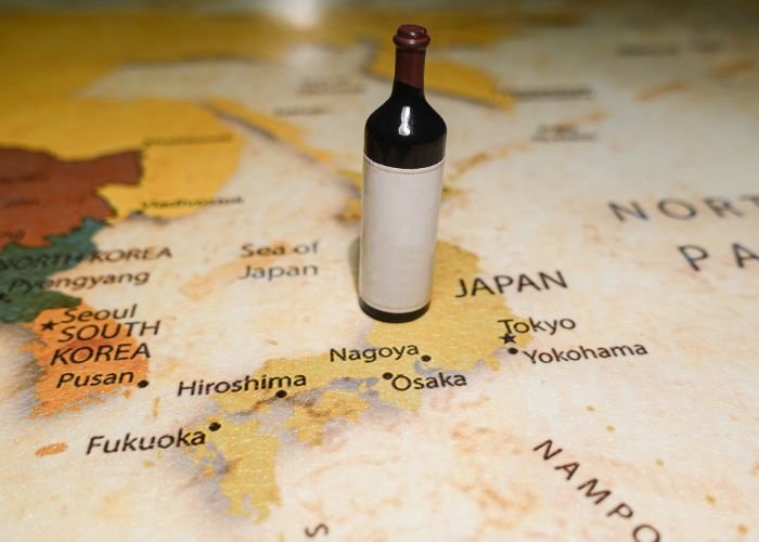 A wine bottle on top of a map of Japan