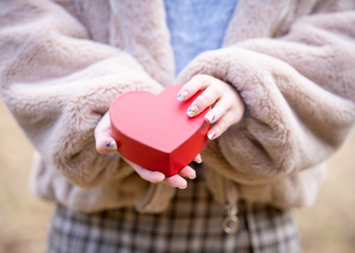 Woman holding a heart shaped box