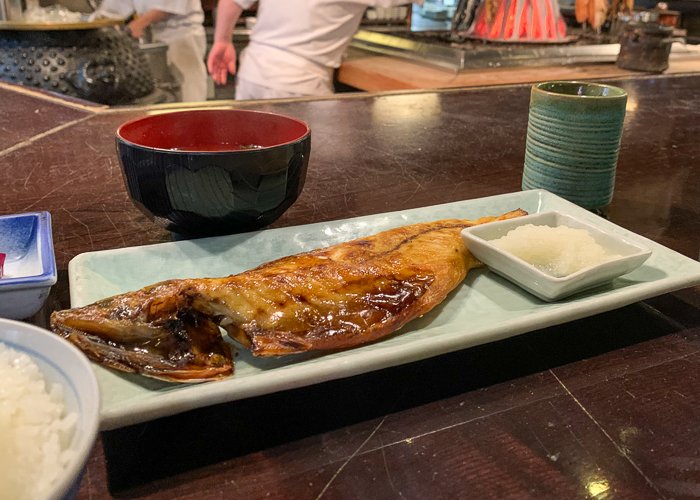 grilled whole fish on a rectangular plate 