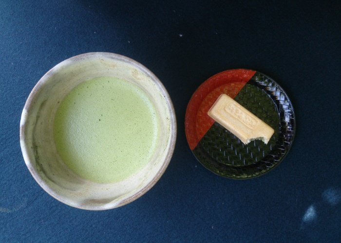 Matcha green tea flat lay with a biscuit
