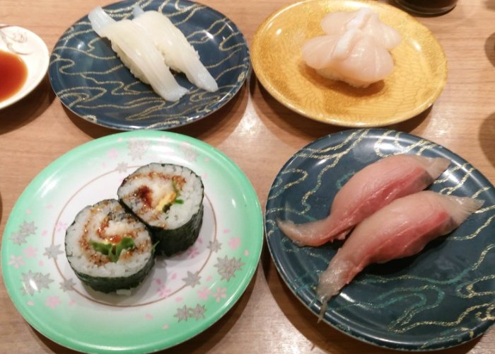4 plates of sushi at a conveyor belt sushi restaurant