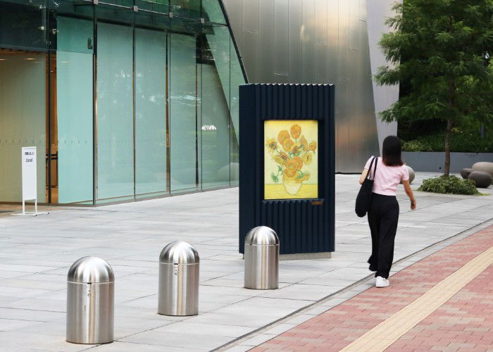 Woman walks by the Sompo Museum of Art