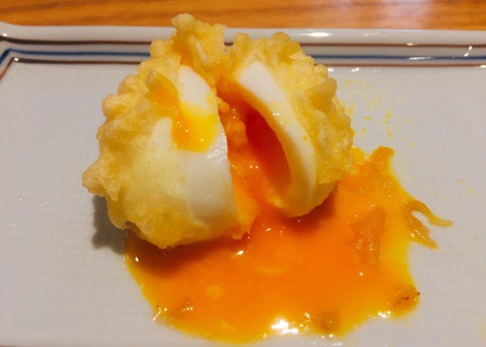 Split egg tempura with yolk running out