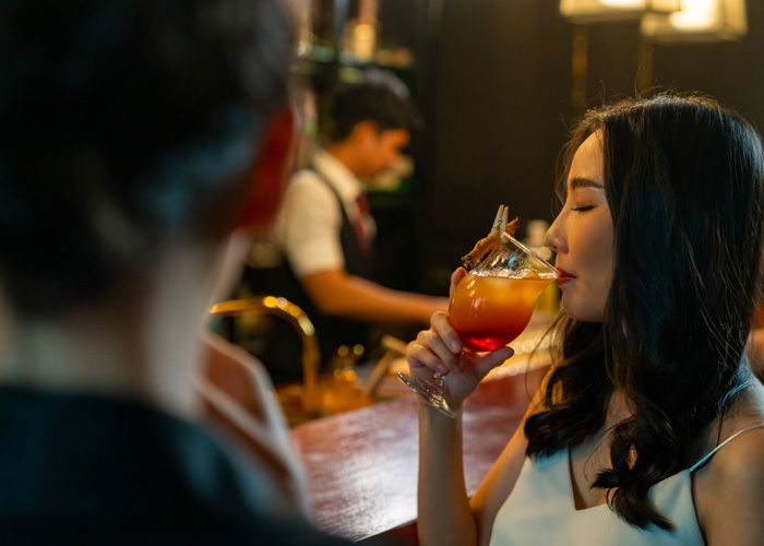 Woman drinking a cocktail