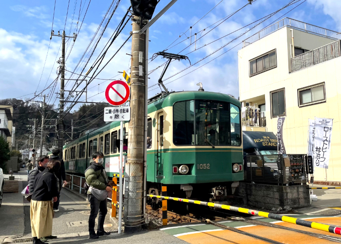 The Enoden train stopped at a crosswalk in Enoshima