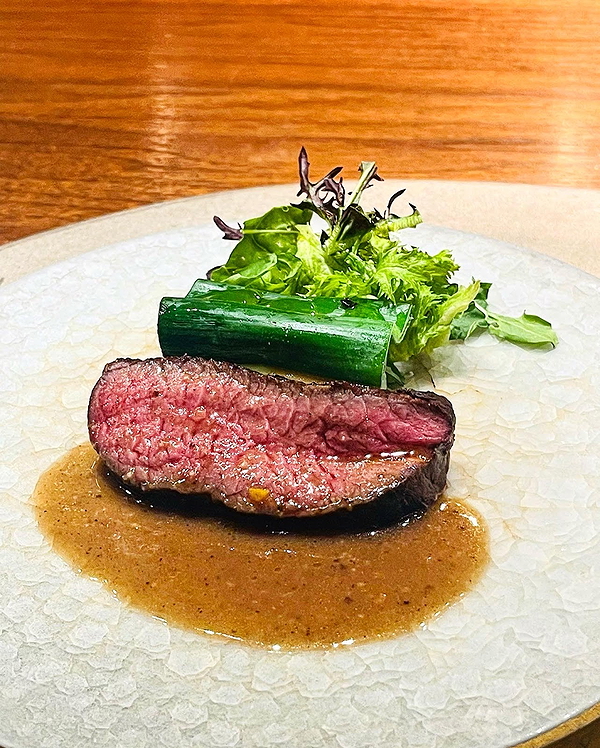 Gourmet steak dish with greens on elegant restaurant plate