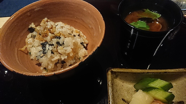 Gourmet rice bowl with Japanese side dishes on a restaurant table