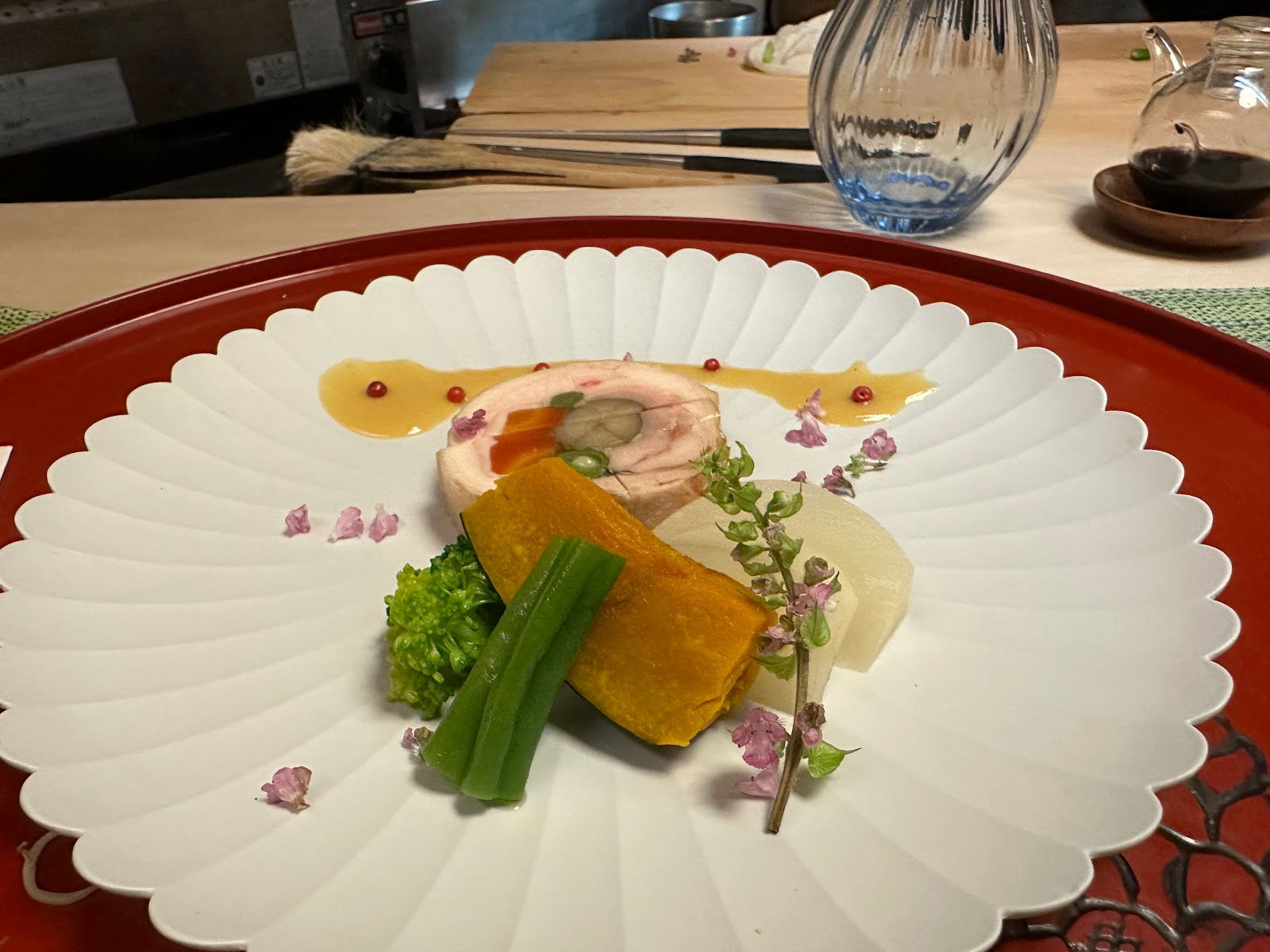 A picturesque plating at Kappo Suzuki, garnished with flora.