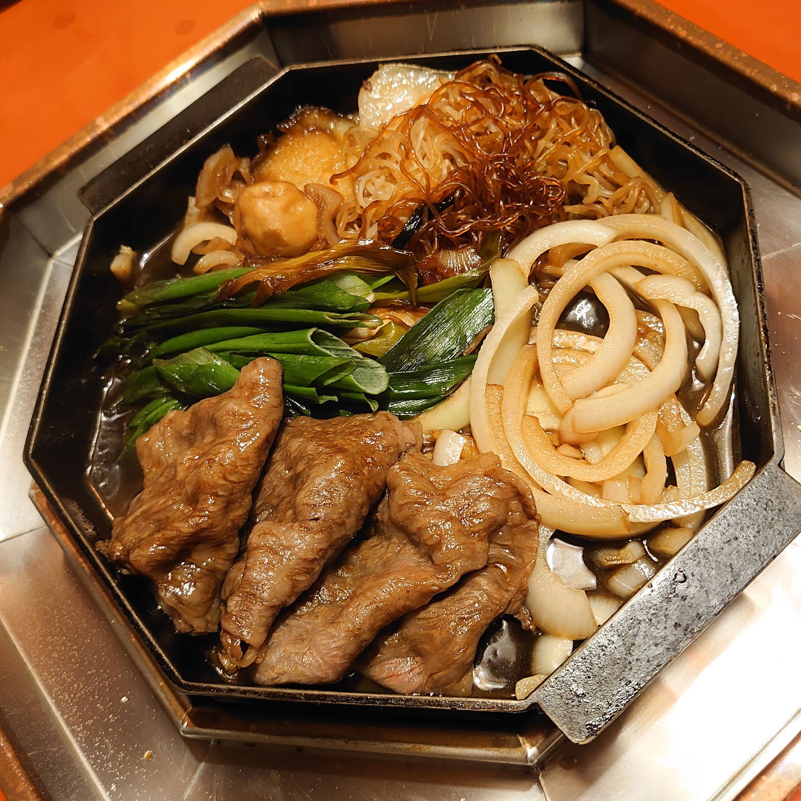 Traditional Japanese sukiyaki with beef and vegetables