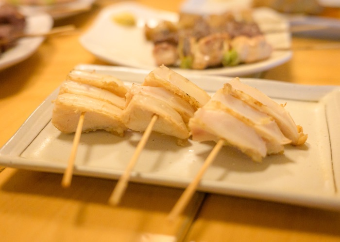 Three cartilage yakitori skewers on a plate.