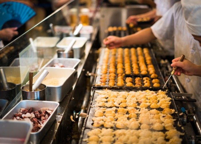 Japanese snack food “Takoyaki” shop at local market in japan