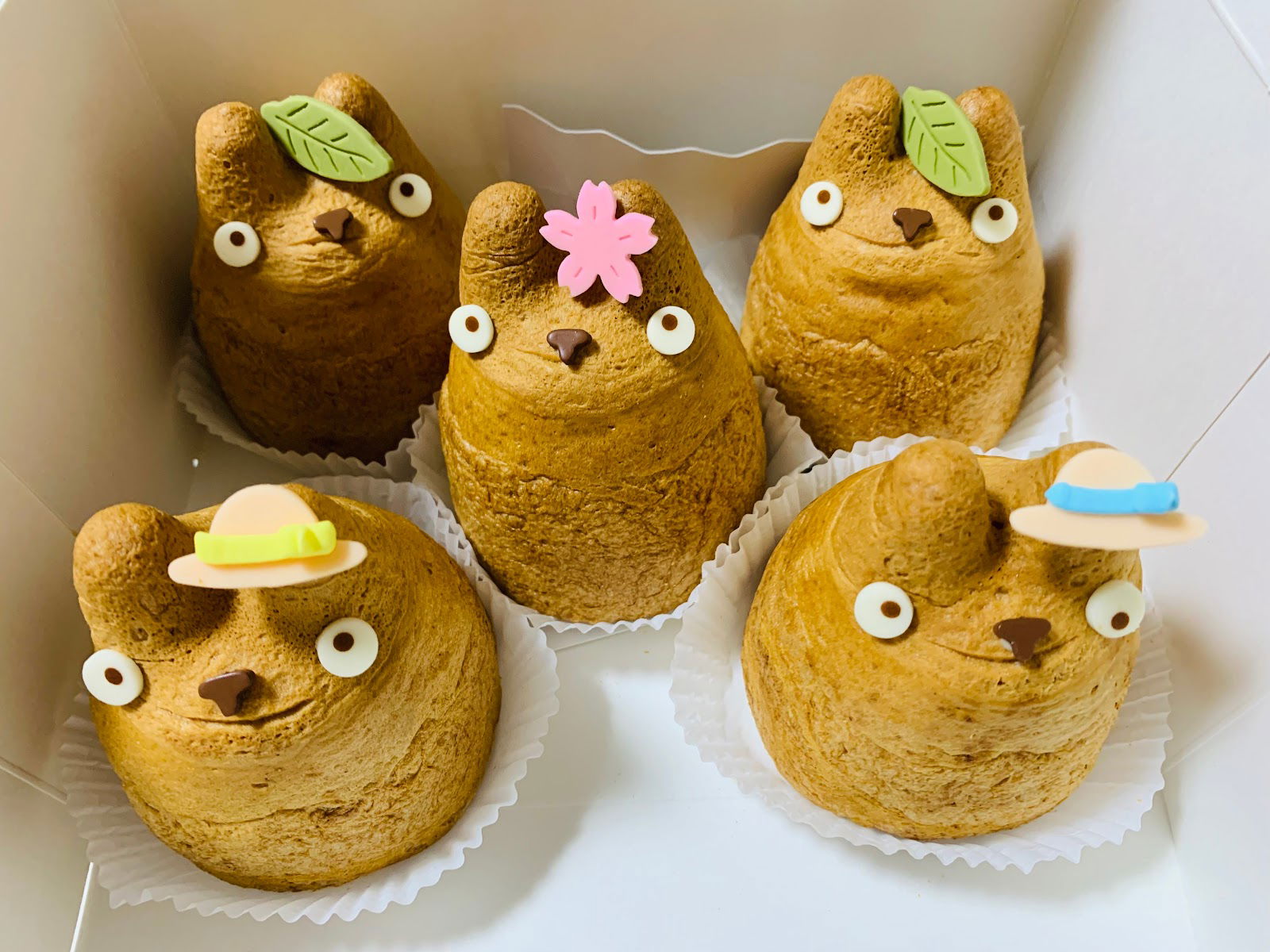 A selection of cute choux pastries from Shirohige’s Cream Puff Shop, looking like Totoro.