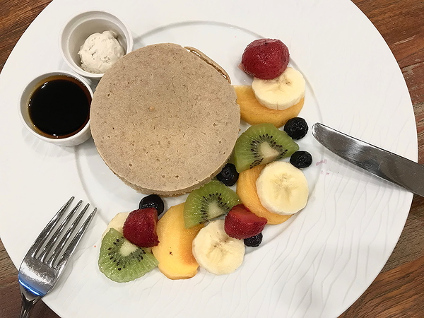 Gourmet pancake breakfast with fresh fruit garnish