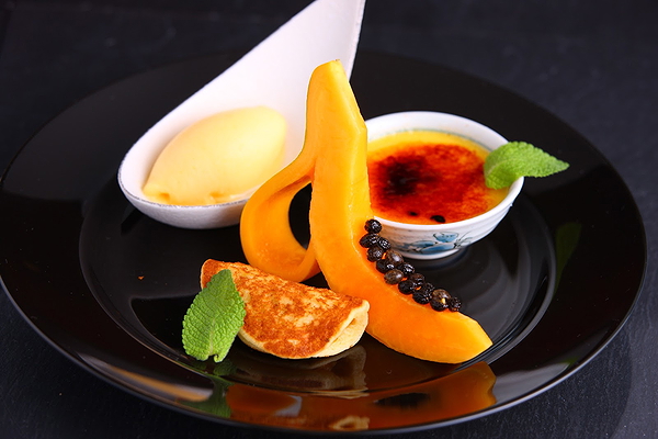 Gourmet dessert with caramel custard and mango sorbet
