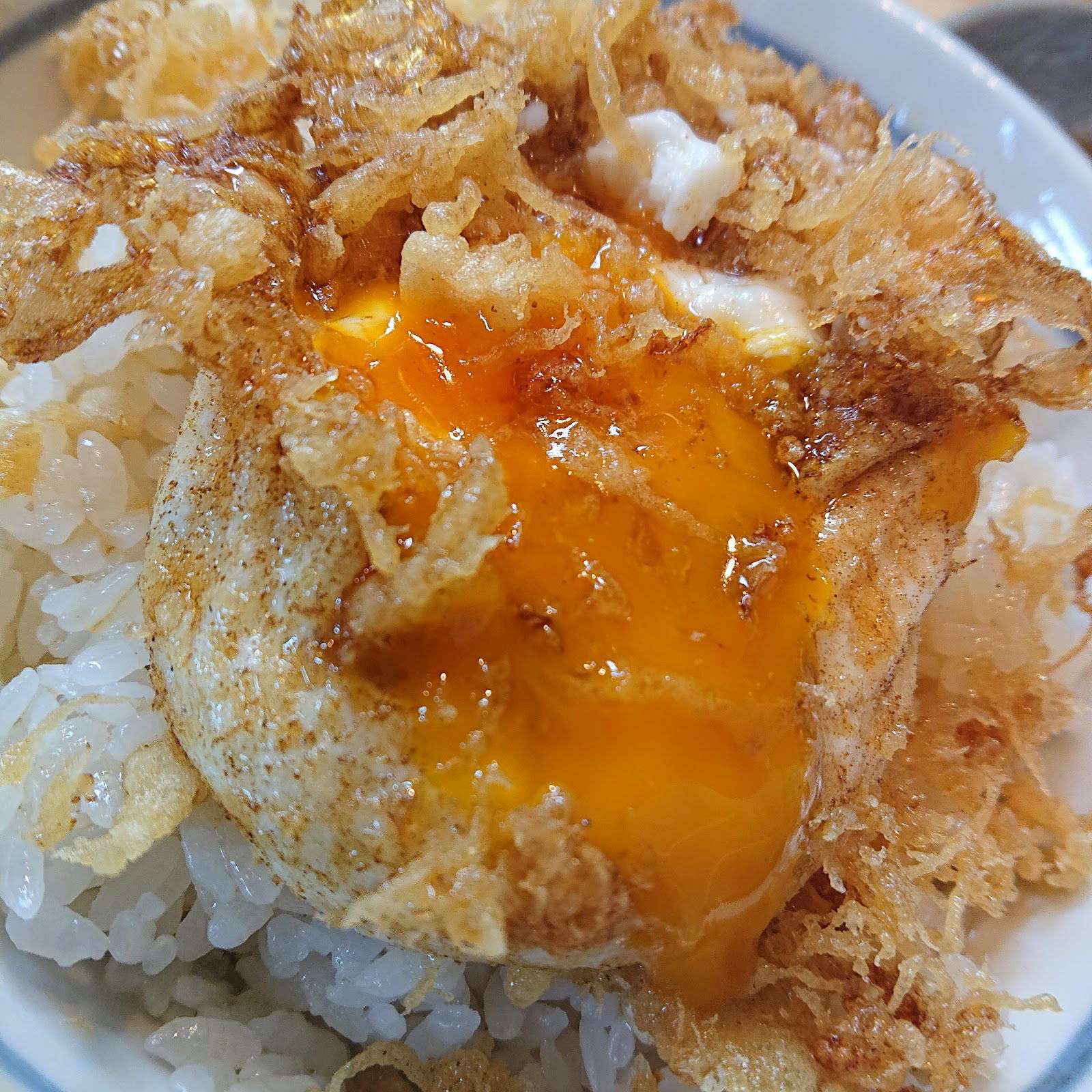 Flavorful fried egg over crispy rice dish