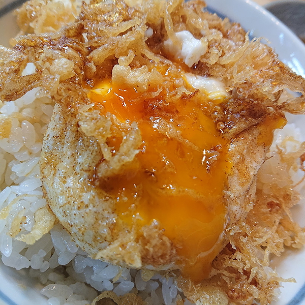Flavorful fried egg over crispy rice dish