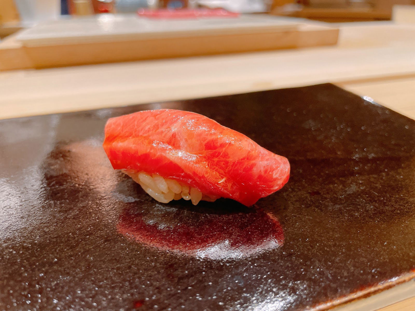 Fresh seafood sliced and laid on vinegared rice at Sushi Rakumi.