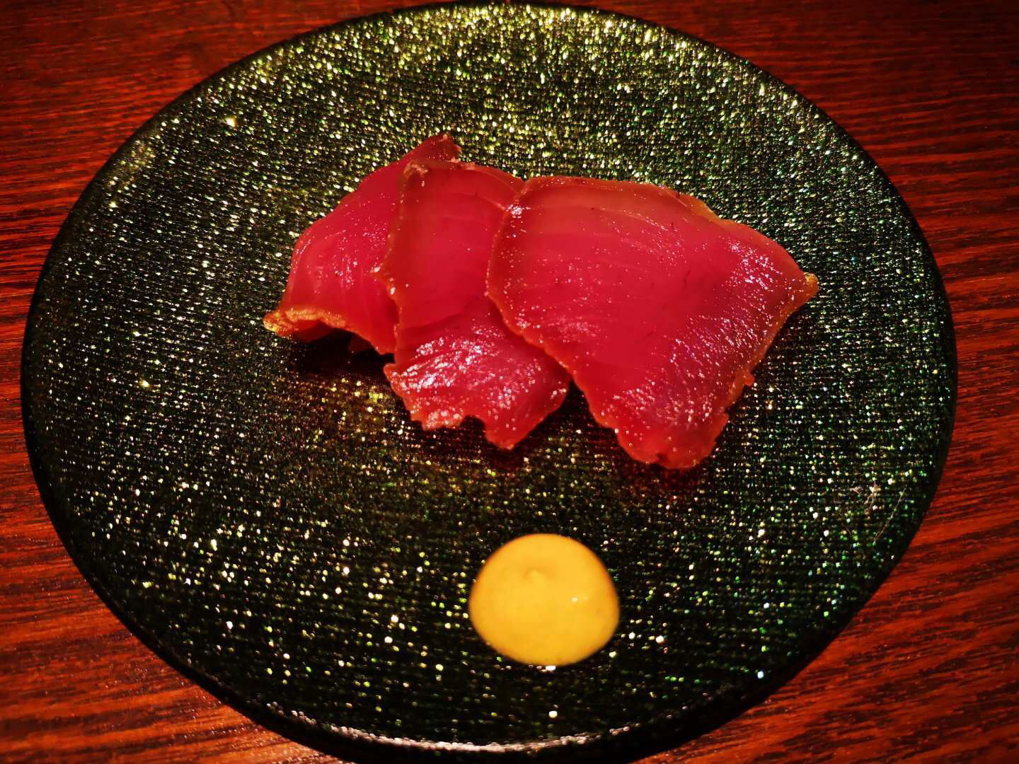 Gourmet tuna sashimi with mustard sauce on elegant plate
