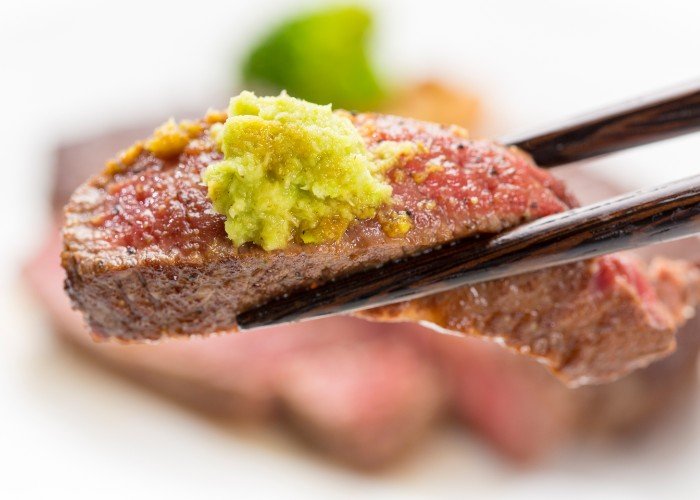 Steak for eating with wasabi in chopsticks