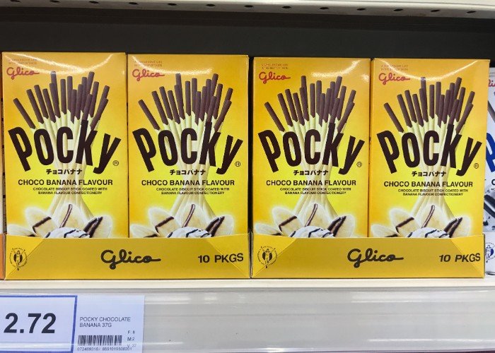 Closeup boxes of Glico POCKY biscuit sticks chocolate banana flavour display for sell in the supermarket shelf