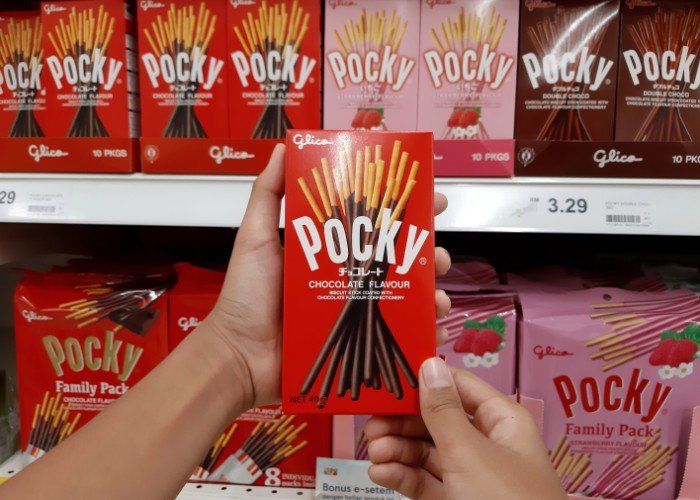 Hands holding a box of Pocky