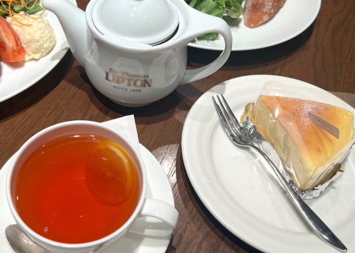 Lunch tea set containing a baked cheesecake, tea pot and cup of hot tea