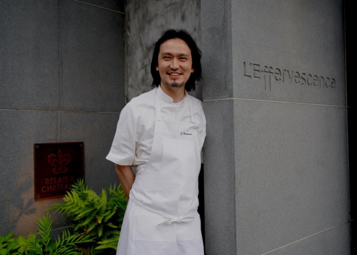 Shinobu Namae poses infront of his restaurant,  L'Effervescence