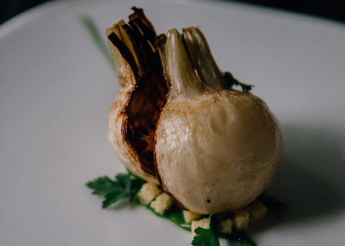 A small and stylish plate of a pan grilled radish presented beautifully