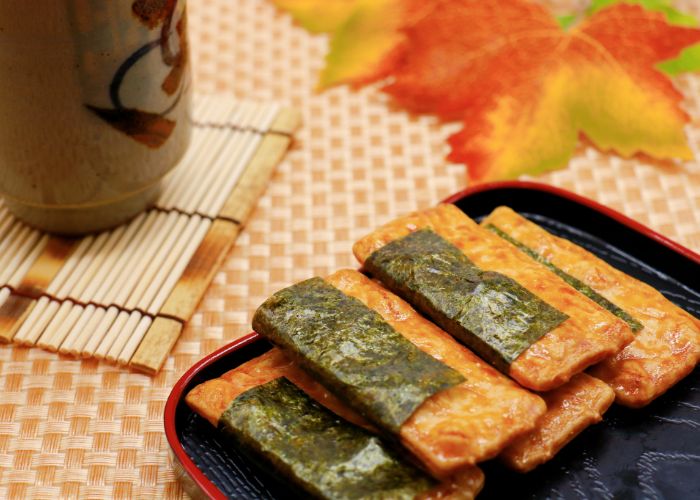 Norimaki rice crackers. Soy sauce flavored rice cracker wrapped with dried laver. A traditional Japanese snack.