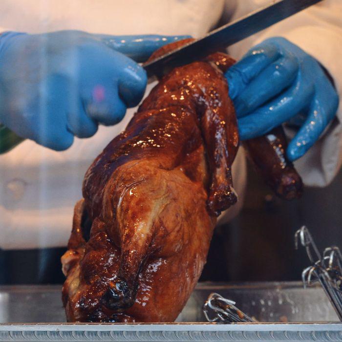 The chef is cutting the Peking Duck 