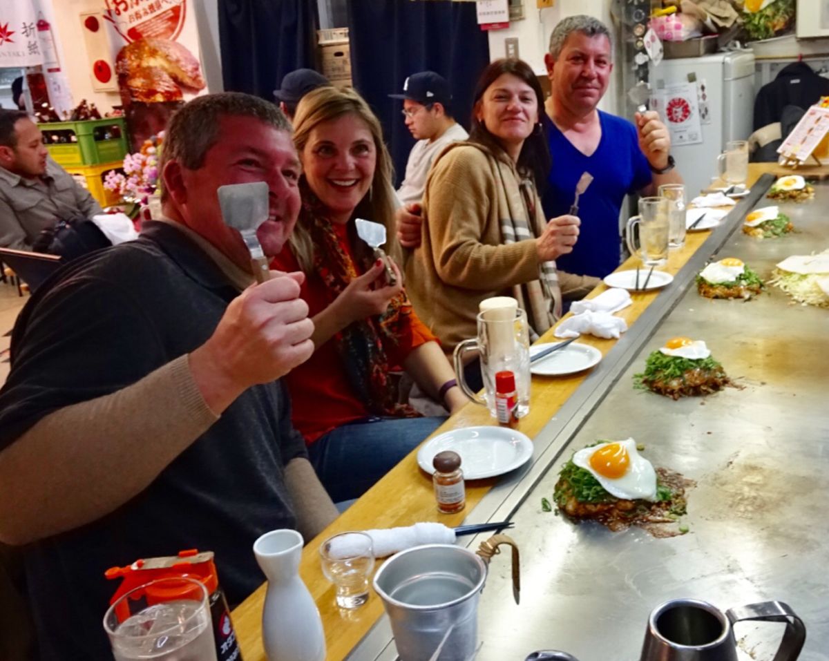 people enjoying Hiroshima style okinomiyaki