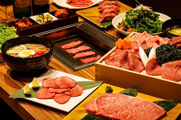Assorted premium meats and dishes at a gourmet restaurant table