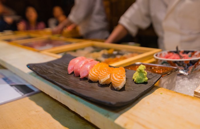 An omakase nigiri sushi platter of maguro and salmon