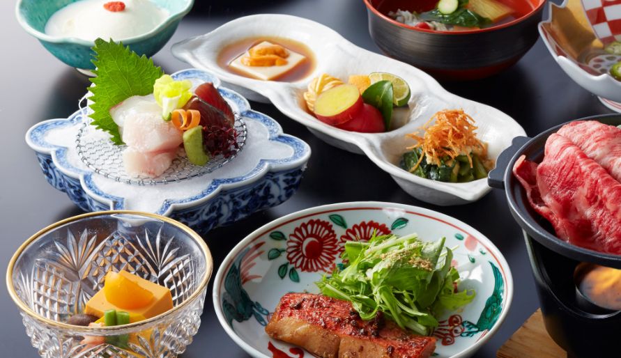 Traditional Japanese kaiseki course with a variety of colorful dishes.